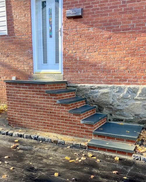 Picture of a brick stairway up to the door of a house
