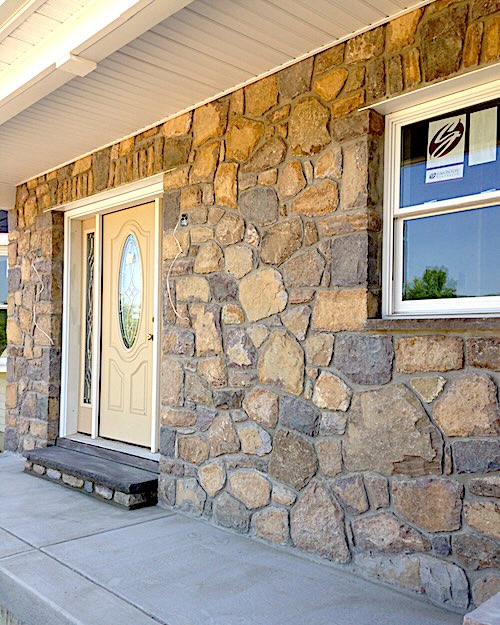 Picture of stonework around the door and window of a house