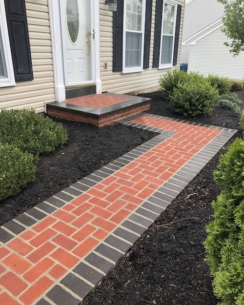 Picture of a brick walkway to the door of a house