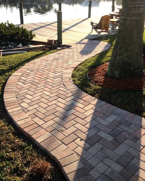 Picture of a brick walkway down to water